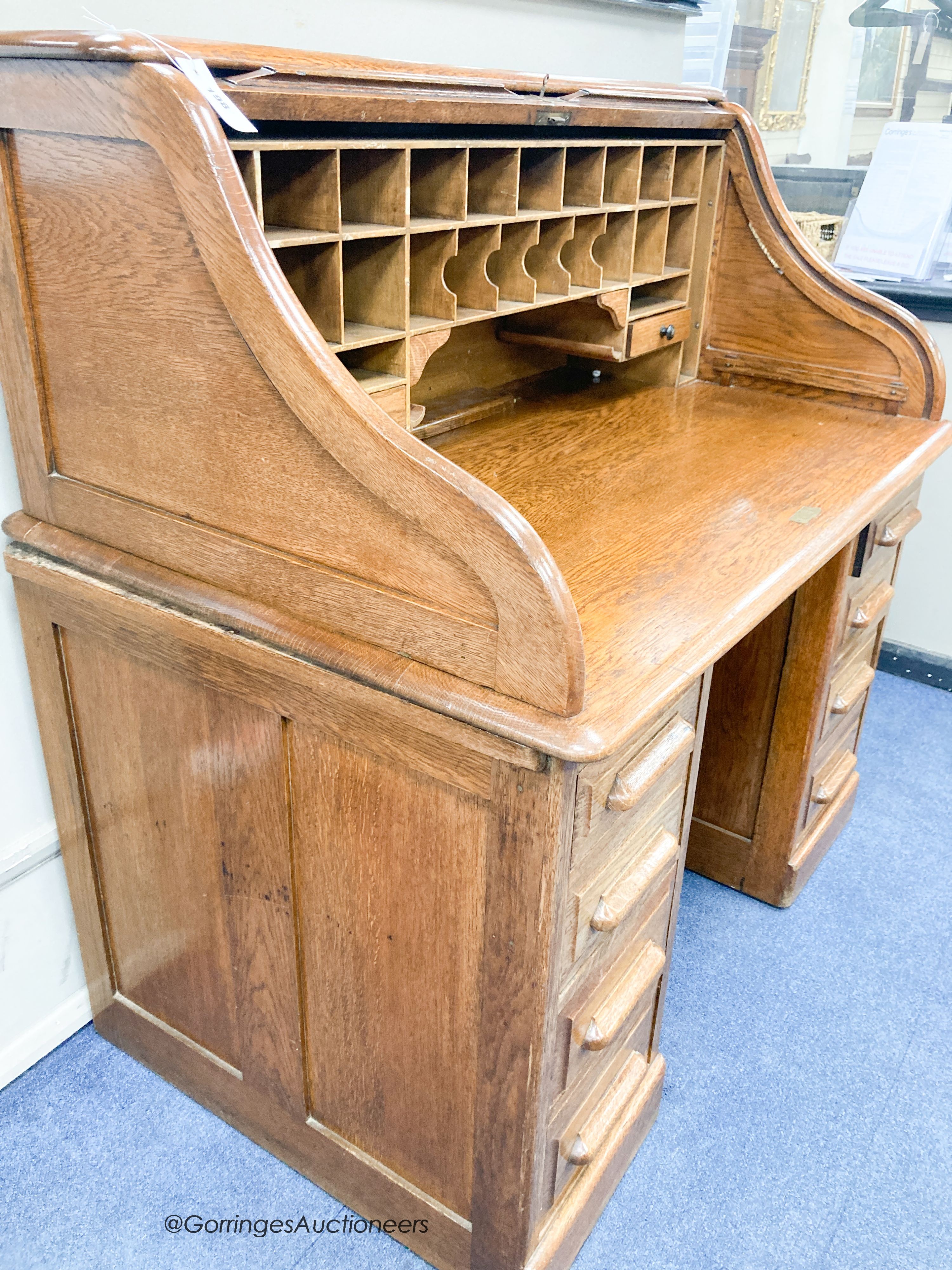 An early 20th century oak roll top desk with 'S' shaped tambour, width 120cm, depth 78cm, height of 124cm